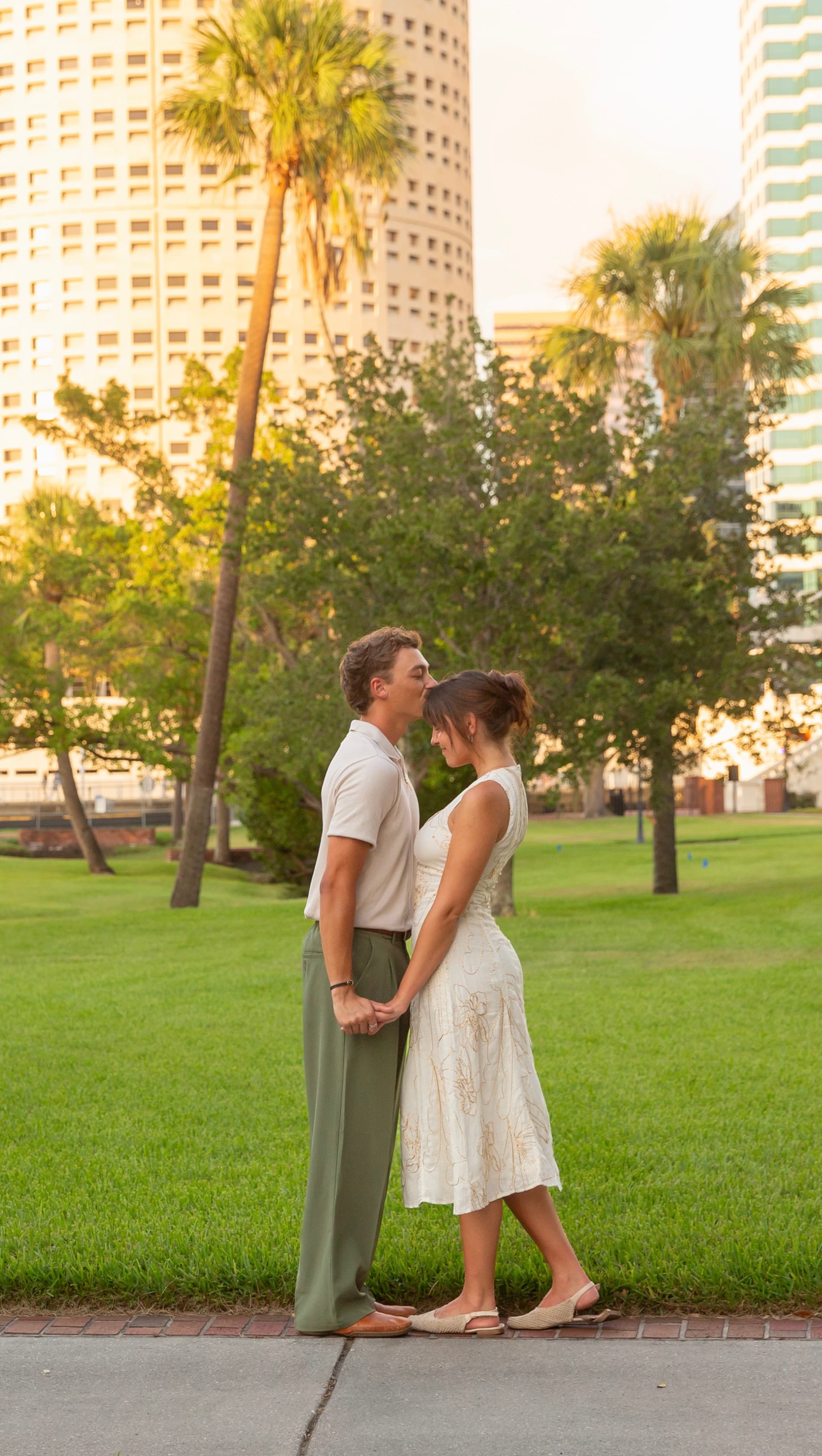 Trey and Annika on the lawn, downtown behind them